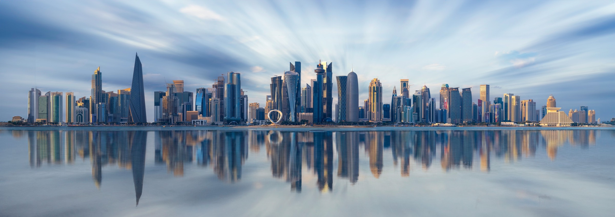 The West Bay skyline of Doha reflected in still water
